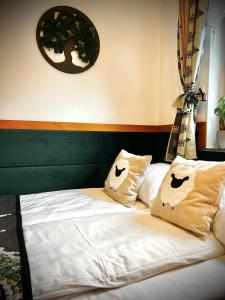 a bed with two pillows on it in a room at Domek pod Tatrami Jurgów noclegi in Jurgów