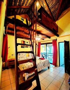 a room with two bunk beds and a bed at Hotelito Swiss Oasis -Solo Adultos - Adults only in Puerto Escondido