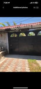 a building with a garage with a large door at Country House in Los Planes. in Panchimalco