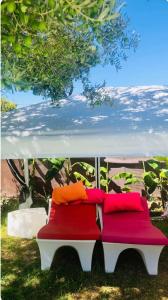 a bench with colorful pillows sitting under a canopy at Villa Amaya in El Puerto de Santa María