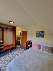 a bedroom with a large bed and a desk at Vila Nana Bled Apartments & Rooms in Bled