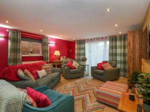 a living room with two couches and a rug at The Forest Coach House in Cinderford