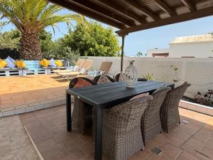 a black table and chairs on a patio at Mountain View Villa in Playa Blanca