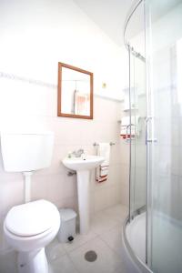 a bathroom with a toilet and a sink and a shower at 3 bedrooms villa with enclosed garden and wifi at Sortelha in Sortelha
