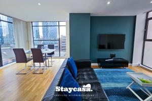 a living room with a couch and a table at Serene One-bedroom With Amazing City Views! in Manchester