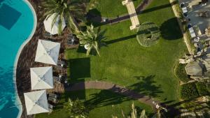 an overhead view of a resort with a pool and palm trees at Hotel Son Caliu Spa Oasis in Palmanova