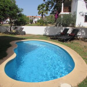 a swimming pool in a yard next to a house at Tortuga Beach Resort 3 Bed Villa with pool in Santa Maria