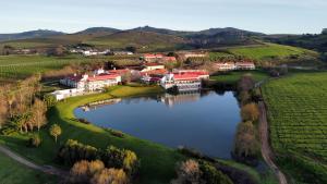 an aerial view of a village with a lake at Asara Wine Estate & Hotel in Stellenbosch