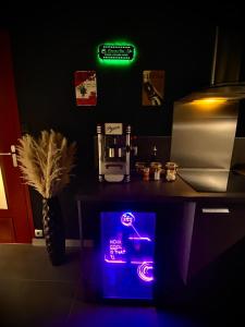 a dark room with a neon sign on a table at L unique Cinéma Room in Grenoble