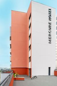 a building with a sign on the side of it at Mercure Sao Paulo Berrini in Sao Paulo