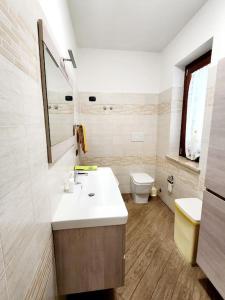 a bathroom with a sink and a toilet at la casa di simone in Torre Tre Ponti +22 photos