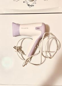 a pink hair dryer with a pair of glasses at Sunshine house in Herceg-Novi
