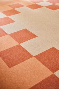 a brown and white checkered floor withcoordinates at Hotel des Victoires - Restaurant in Cannes