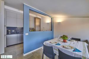 una sala da pranzo con tavolo e parete blu di Casa Posta a Varenna