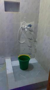 a shower with a bucket in the corner of a bathroom at D'Island Hotel and Club in Lekki