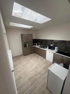 a large kitchen with a skylight in the ceiling at Logement Bonheur 