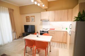 a kitchen with a table and chairs and a refrigerator at Elena's nest in Kastoria
