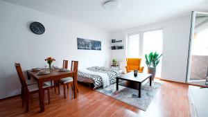 a living room with a table and a dining room at Apartmán u METRA, 4 hosté, parking free, blízko O2 arena in Prague