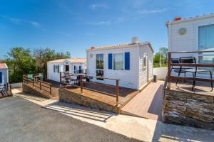 a mobile home with a large deck in a parking lot at Quinta Solar da Portela in Almodôvar