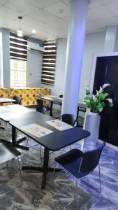 pokój ze stołami i krzesłami oraz doniczką w obiekcie Ceetran Hotels w mieście Port Harcourt