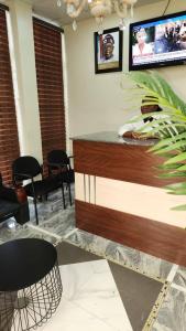 a bar with chairs and a counter in a room at Ceetran Hotels in Port Harcourt
