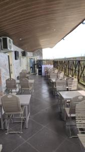 a row of tables and chairs in a restaurant at Ceetran Hotels in Port Harcourt