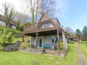 a house with a large deck on top of it at Valley Lodge 44 in Callington