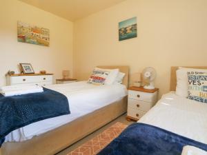 a bedroom with two beds and two night stands at Valley Lodge 44 in Callington +33 photos