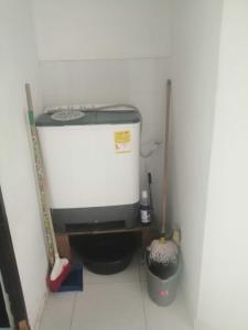 a small bathroom with a toilet and a water tank at apto centro santa marta in Santa Marta