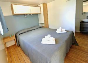 a hospital room with a bed with towels on it at Villaggio Acquamarina in Pisciotta