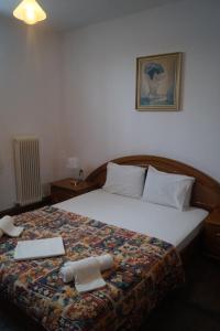 a bedroom with a bed with two towels on it at Tea's sea apartments in Siviri