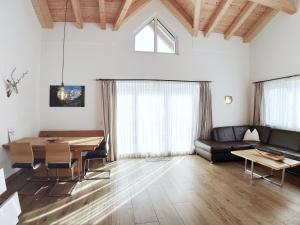 a living room with a table and a couch at KitzviewTerrace in Zell am See