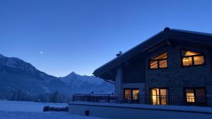 a house with the mountains in the background at Apart-Chalet Kitzblick in Zell am See