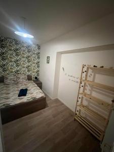a bedroom with a bed and a ladder in it at Logement Bonheur 