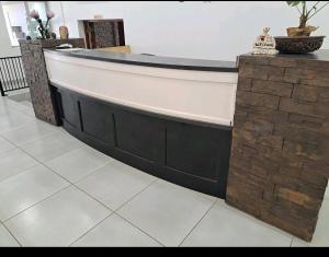 a bath tub in a room with a tile floor at Nikita Portuguese Restaurant and Motel in Lanseria