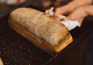 a person holding a loaf of bread on a table at Posada Gotan in Buenos Aires