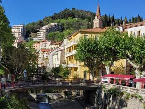 a bridge over a river in a city with buildings at Appartement A Beholding Sight in Amélie-les-Bains-Palalda