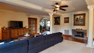 a living room with a blue couch and a fireplace at Willa Wuja Sama in Zawóz