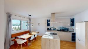 a kitchen and dining room with a table and chairs at Kitzview Idyll in Zell am See