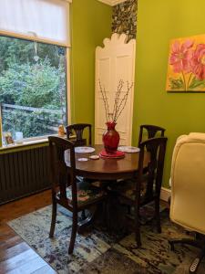 a dining room with a table with chairs and a vase on it at 6 Trinity grove Ella street HU5 3BB in Hull