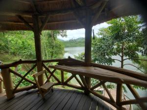 a porch with a view of a river at Dave the Cave Eco Lodge and Cultural Campsite in Rubirizi