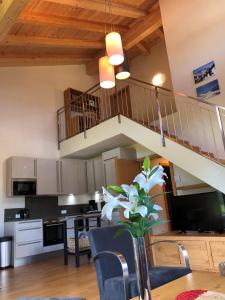 a kitchen and dining room with a spiral staircase at Apart-Chalet Kitzblick in Zell am See