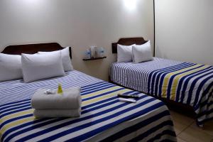 Postel nebo postele na pokoji v ubytování Hotel Mateos 1215