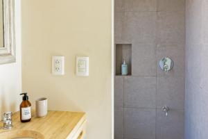 a bathroom with a shower and a sink at Miramonte Posada in Ciudad Lujan de Cuyo