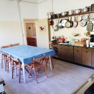 cocina con mesa azul y sillas en Ostello di Pontito, en Lanciole