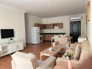 a living room with a couch and a table at Blue Horizon Suites in Manama