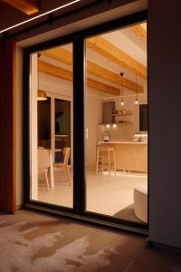 a sliding glass door leading to a kitchen and dining room at romantic cabin Methuya in Teplice nad Metují