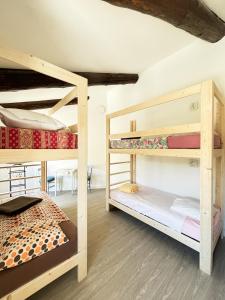 a room with three bunk beds in a house at Gîte de l'Escanson un temps pour soi in Robion en Luberon