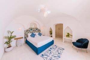 a bedroom with a bed and a chair at Villa Mary Suites in Positano