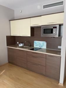 a kitchen with a sink and a microwave at CentralVibeWro in Wrocław